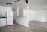 updated kitchen with white cabinets, black countertops, and vinyl plank flooring