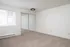 updated bedroom with new carpet, light fixtures, and mirrored closet doors, and large mirror with wood blinds