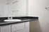 updated black bathroom countertop and round undermount sink and white cabinets