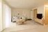 Bright and modern living room featuring neutral tones, contemporary furniture, and abundant natural light&mdash;perfect for relaxing or entertaining.