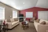 Living room area with tv and fireplace located in the community building at Meadow Crest apartments in Vancouver, WA