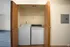 Photo of in-unit laundry with shelving and doors for privacy inside 2 bed, 1 bath unit at Meadow Crest apartments