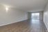 Large and spacious living area with sliding glass doors leading at The Maples in Portland, OR