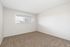 Additional interior bedroom with large, bright window at The Maples apartments in Portland, Oregon