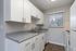 Inerior kitchen with modern features and flooring at The Maples apartments in Portland, OR