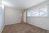 Additional interior photo of spacious bedroom with large window allowing in ample natural light at The Maples apartments in Portland, OR