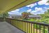 Exterior photo featuring private patio attached to apartment units overlooking greenery at The Maples apartments in Portland, OR