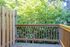 Charming wooden deck with a lush green backdrop perfect for relaxing in a serene natural setting.