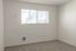 Bright and cozy room with large window offering natural light and serene views, perfect for a tranquil living space.