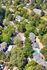 Captivating aerial view of a serene residential community nestled amidst lush greenery, showcasing a harmonious blend of modern living and natural beauty.