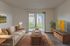 Bright and inviting living room with elegant furniture, a cozy sofa, and a large sliding glass door leading to a scenic outdoor view, virtually staged for a modern appeal.