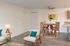 Elegant, virtually staged living room featuring modern furniture, a stylish round dining table, and sleek flooring, perfect for a cozy and sophisticated home.