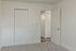 Bright room with soft carpeting and sleek double doors, perfect for modern living.