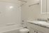 Elegant bathroom featuring a sleek bathtub, modern shower, and chic marble countertop.