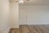 Inviting apartment entryway with elegant wood flooring and a modern ceiling fan.