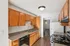 Charming kitchen with warm wooden cabinets, sleek countertops, and modern appliances, offering a cozy yet functional cooking space.