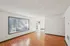 Bright and spacious living area with elegant hardwood flooring and large windows offering natural light.