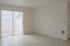 Bright and airy living space with large sliding glass doors and elegant light wood flooring, perfect for modern living.