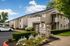 Charming Aspen Grove apartments showcasing modern two-story design with well-maintained landscaping and inviting entryway.