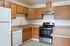 Modern kitchen with elegant wooden cabinetry, stainless steel appliances, and sleek countertops.