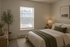 Cozy bedroom with elegant decor, featuring a plush bed adorned with green accents, soft lighting, and a large window offering natural light.