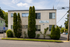 Charming residential building surrounded by lush greenery and a welcoming neighborhood ambiance.