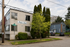 Charming apartment building, Melissa Anne, nestled on a quiet street with lush greenery and convenient parking.