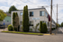 Charming two-story apartment building with lush landscaping and a welcoming facade.