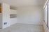 Bright and airy space featuring plush carpet, large windows offering natural light, and an inviting open layout.