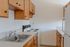 Cozy kitchen with natural wood cabinets, modern appliances, and spacious countertops.