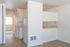Inviting apartment interior showcasing a bright open kitchen and living space with modern wooden flooring.