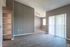 Bright open-concept living space with elegant wood flooring, built-in shelving, and large sliding glass doors offering abundant natural light.