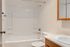 Bright and inviting bathroom with a modern bathtub, sleek mirror, and contemporary sink design.