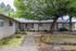 Charming suburban home with lush greenery and mature trees, offering a peaceful and inviting atmosphere.