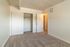Bright bedroom with cozy carpeting, spacious closet, and elegant wood panel ceiling.