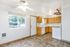 Bright and inviting kitchen with natural wood cabinetry, modern appliances, and ample natural light from a large window.