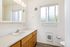 Bright modern bathroom with sleek vanity and ample natural light.