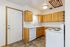 Inviting kitchen with modern appliances, sleek countertops, and ample wooden cabinetry, perfect for culinary enthusiasts.