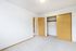 Bright and airy bedroom with a spacious closet, featuring fresh paint and natural light.