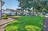 Charming residential complex featuring well-maintained lawns, mature trees, and inviting two-story homes.