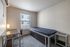 Bright and cozy bedroom with a modern desk and comfortable single bed, perfect for students or professionals.