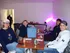 Group of friends enjoying a relaxed gathering in a modern room with snacks and drinks.