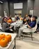 Joyful group of friends engaged in a vibrant pumpkin painting activity, showcasing creativity and fun.