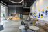 Modern lobby with stylish seating, vibrant wall art, and festive holiday decorations, creating an inviting and contemporary atmosphere.