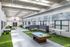 Bright and spacious indoor reflection room featuring modern seating, recreational games, and vibrant decor, perfect for relaxation and community gatherings.