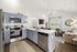 Bright and contemporary open-concept kitchen and living area with modern appliances, sleek cabinetry, and elegant decor.