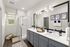 Elegant bathroom featuring a modern double sink vanity, chic lighting, and a glass-enclosed shower, perfect for a stylish living experience.