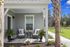 Inviting porch with cozy seating and lush greenery, perfect for relaxation. Exterior features charming architecture and vibrant surroundings.