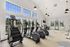 Bright and modern fitness center with large windows, featuring state-of-the-art cardio equipment in a spacious, inviting atmosphere.