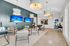 Elegant communal lounge with modern seating, dual flat-screen TVs, chic pendant lighting, and sophisticated wall art for a luxurious ambiance.